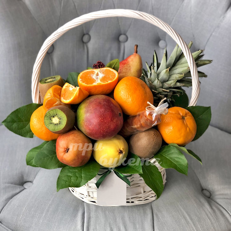 Мандарины, киви и ананас в корзине (на кресле)